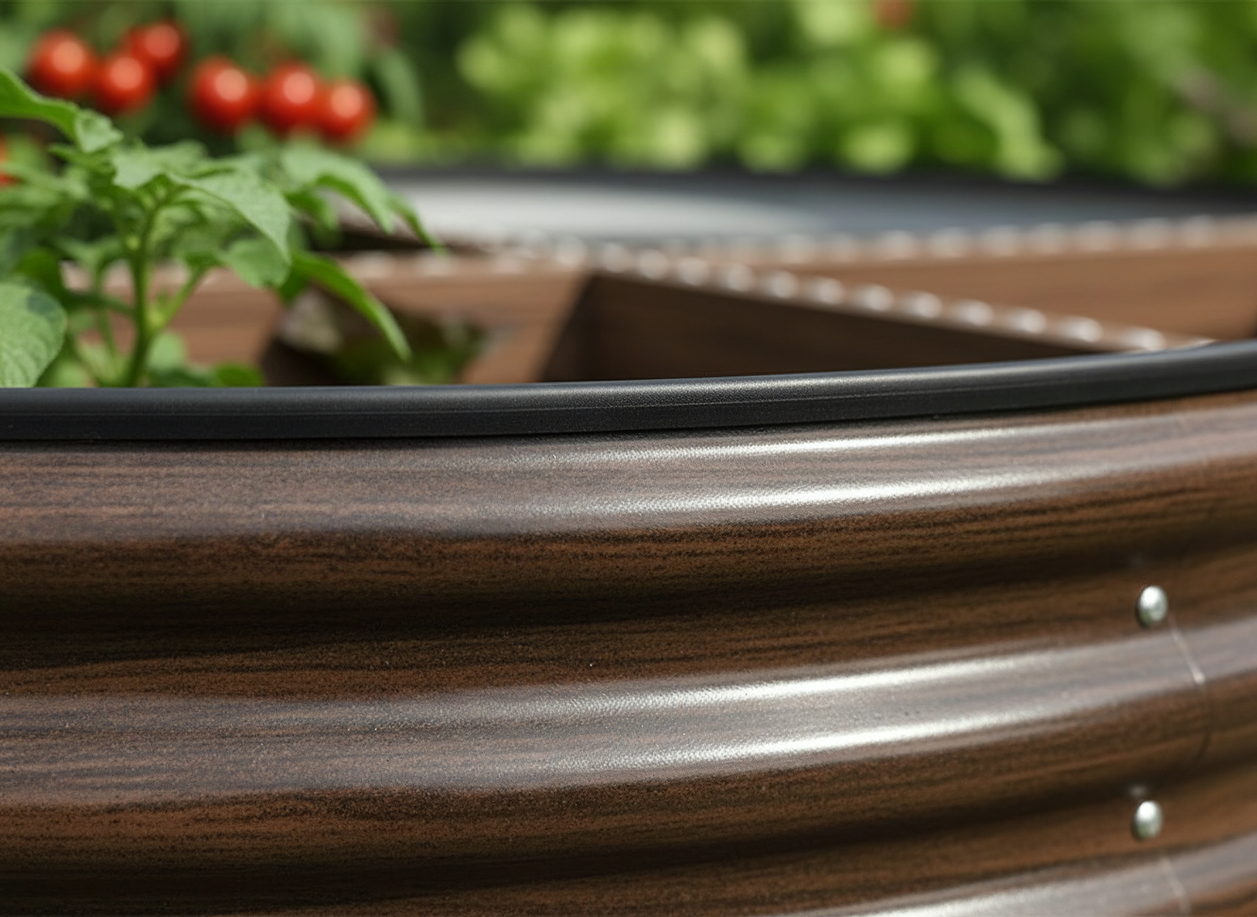 Close-up of thickened corrugated steel and rubber edging on oval raised garden bed, brown finish